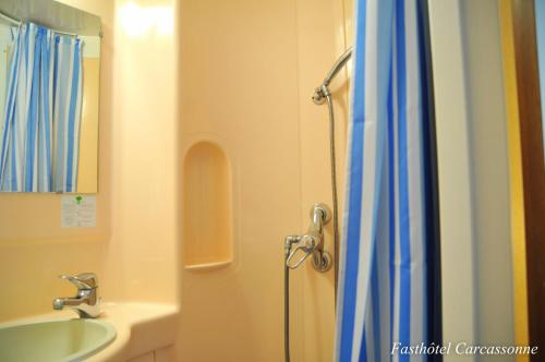 a bathroom with a shower and a sink at Fasthotel Carcassonne in Carcassonne