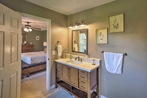 une salle de bain avec un lavabo et une chambre avec un lit dans l'établissement Game Room and Spacious Yard 10-Acre Catskills Home!, à East Durham