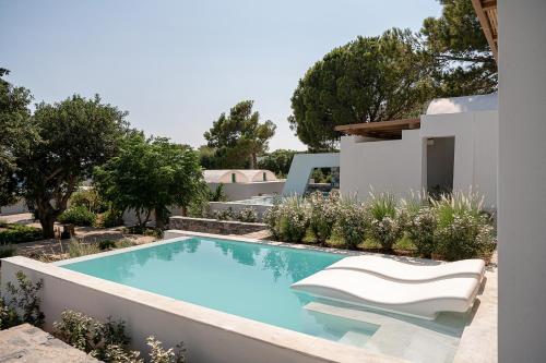 a swimming pool in the backyard of a house at Kakkos Bay Hotel and Bungalows in Ierápetra