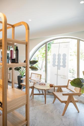 a room with wooden furniture and a large window at Kakkos Bay Hotel and Bungalows in Ierápetra