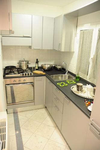 a kitchen with a sink and a stove top oven at Trevi 86 in Rome