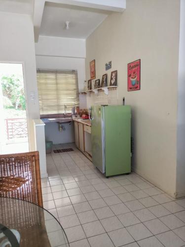 a kitchen with a green refrigerator in a room at Port Dickson Seaview Homestay in Port Dickson