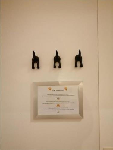 a white wall with three black cats on it at The pop-art luxury suite in Charleroi
