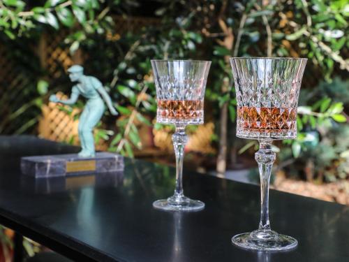 two wine glasses sitting on top of a table at The Iflissen Pavilion - Luxury Villa in Lamorlaye