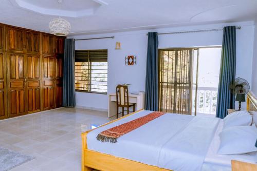 a bedroom with a bed and a large window at Nature Kigali in Kigali