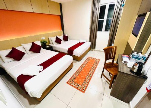 Un pat sau paturi într-o cameră la City Central Hotel