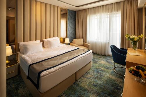 a hotel room with a large bed in a room at Admiral Hotel - Ultra All Inclusive & Private Beach in Golden Sands