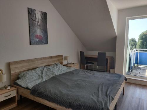 a bedroom with a bed and a large window at Fewo Bernau in Bernau bei Berlin