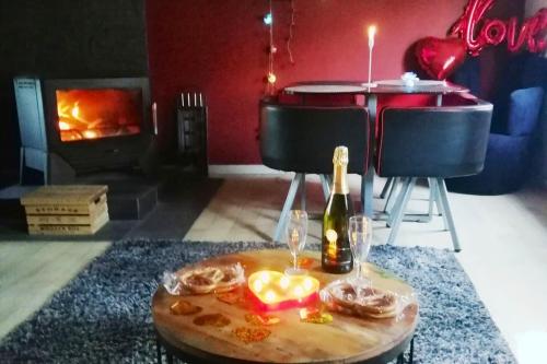a living room with a table with a bottle of wine and a table with at Maison de charme à Wangen avec piscine privée et jardin in Wangen