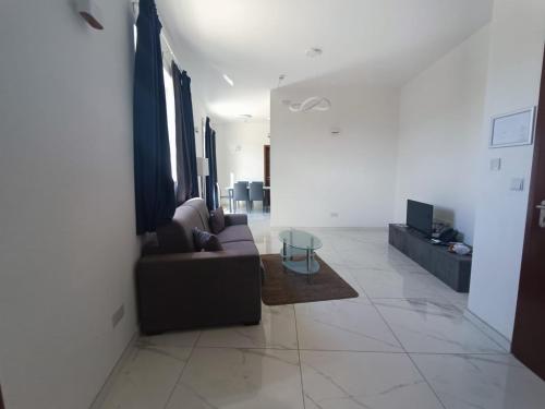 a living room with a couch and a table at Blu-M Central in Qormi