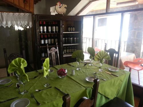 a table in a restaurant with a green table cloth at Hosteria Iloca in Iloca