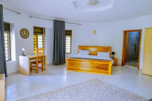 a bedroom with a bed and a table and a chair at Nature Kigali in Kigali