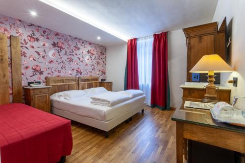 Ένα ή περισσότερα κρεβάτια σε δωμάτιο στο Hotel Berthod