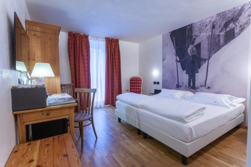 Ένα ή περισσότερα κρεβάτια σε δωμάτιο στο Hotel Berthod