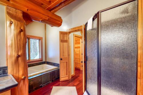 a bathroom with a bath tub and a shower stall at Snow Lion in Carrabassett