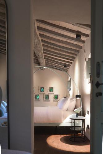 a bedroom with a white bed with a ceiling at Vocabolo Moscatelli in Calzolaro
