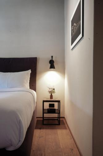 a bedroom with a bed and a side table at Vocabolo Moscatelli in Calzolaro