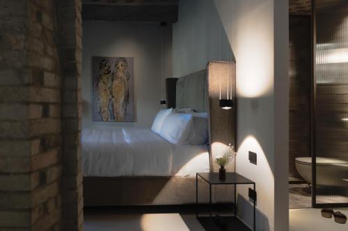 a bedroom with a bed with a painting on the wall at Vocabolo Moscatelli in Calzolaro