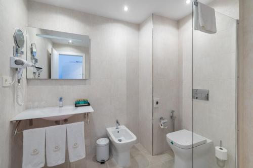 a bathroom with a toilet and a sink and a shower at Hotel Soul de Javea in Jávea