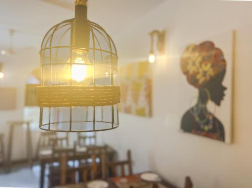 a bird cage hanging from the ceiling of a dining room at Shoki Shoki Hotel Stone Town in Zanzibar City