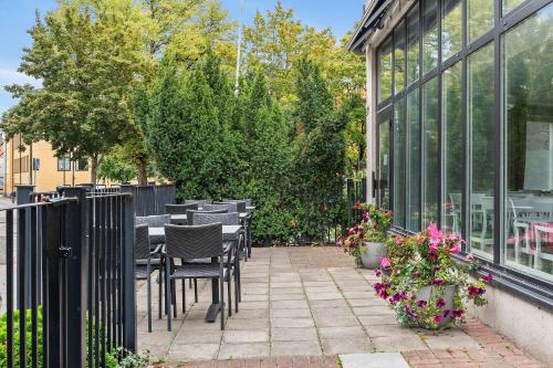 a patio with tables and chairs next to a building at Best Western Hotel Esplanade in Västerås