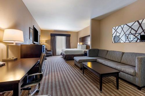 a hotel room with a couch and a bed at Best Western Plus North Odessa Inn & Suites in Odessa