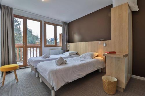 Ένα ή περισσότερα κρεβάτια σε δωμάτιο στο Hôtel Le Chamois d'Or, USSIM Vacances Méribel