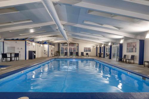 a large swimming pool with blue water in a building at Best Western Downtown Casper Hotel in Casper