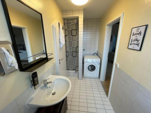 a bathroom with a sink and a washing machine at City-Wohnen in Düren im Boho-Style in Düren - Eifel