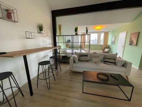 a living room with a couch and a table at City-Wohnen in Düren im Boho-Style in Düren - Eifel