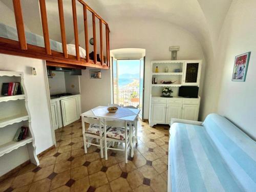 a living room with a table and a kitchen at Florenza Residence in Sperlonga