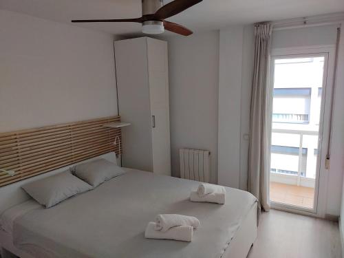 a bedroom with a bed with two towels on it at Luxury Apartment Accommodation, next to beach & train station Calella in Calella