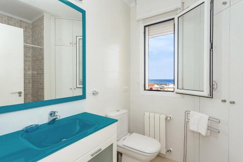 bagno con lavandino, servizi igienici e finestra di Binicasal a Sant Lluís