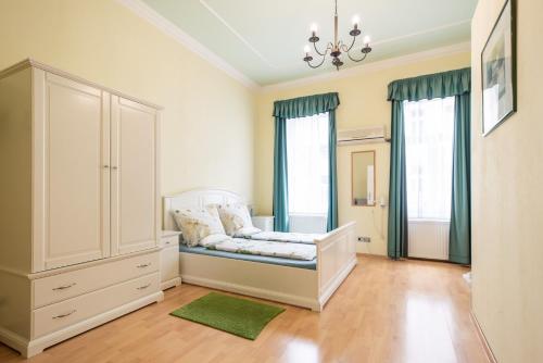 a bedroom with a bed and a large window at Pension Primavera in Vienna