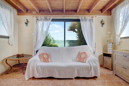a bedroom with a bed and a large window at Casa Albryna Lanzarote in Tahiche