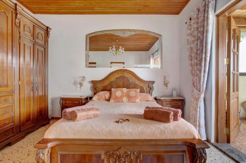 a bedroom with a large bed and a mirror at Casa Albryna Lanzarote in Tahiche
