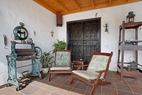 a room with two chairs and a door at Casa Albryna Lanzarote in Tahiche