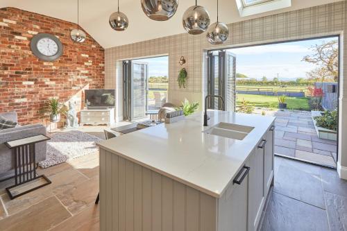 a kitchen with a counter and a living room at Host & Stay - The Stables in Yarm