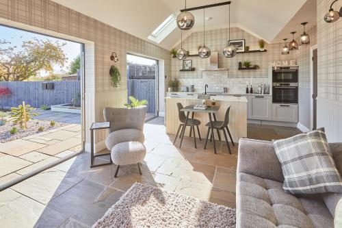 a kitchen and living room with a table and chairs at Host & Stay - The Stables in Yarm