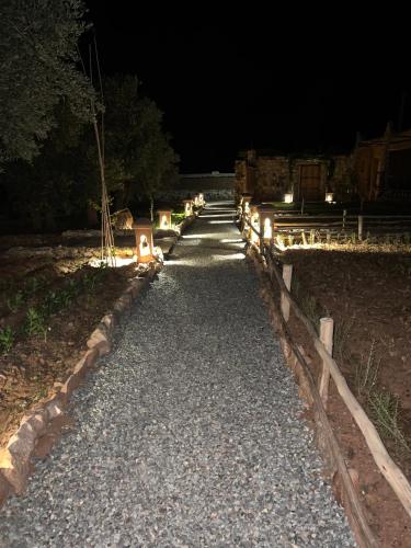 a gravel pathway at night with lights on it at Bin Jbal Resort in Ouirgane