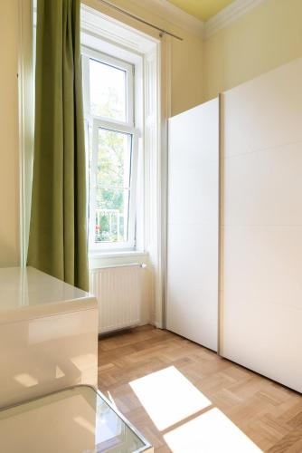 a room with a white door and a window at Pension Primavera in Vienna