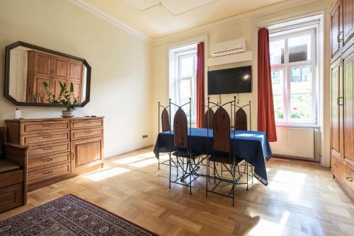 a dining room with a blue table and chairs at Pension Primavera in Vienna