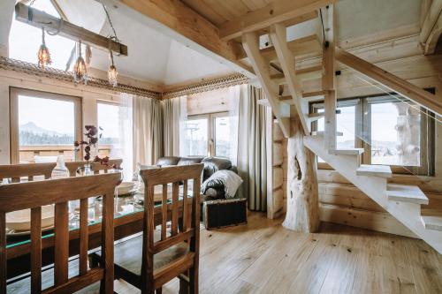 a living room with a staircase in a house at Górski Domek DeLux in Małe Ciche