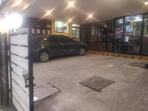 a car parked in a parking lot in a garage at Season 4 Residences -Thiruvanmiyur Near Tidel park Apollo Proton cancer center and IIT Madras Research Park in Chennai