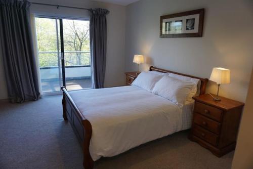 a bedroom with a bed and a window with a view at Rarooey House in Donegal