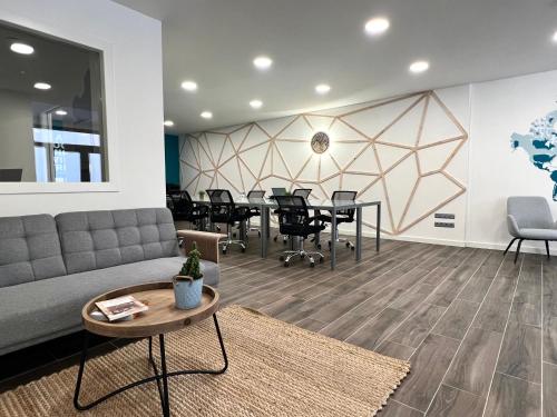 a waiting room with chairs and a couch at Espot Cowork & Apartments - L'Amfitriona in Espot
