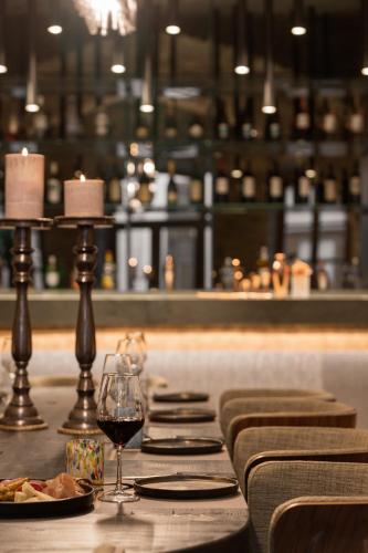 a table with plates of food and a glass of wine at Castro Hotel Syros in Ermoupoli