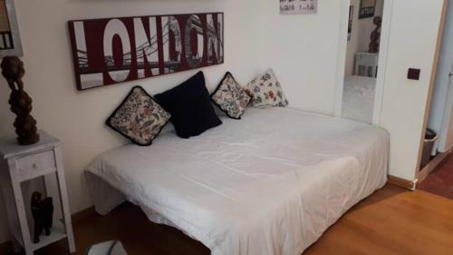 a bedroom with a white bed with pillows on it at Sol y playa in Benalmádena