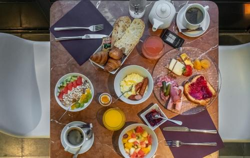 Una mesa con alimentos y bebidas para el desayuno. en Château des Reynats, en Chancelade