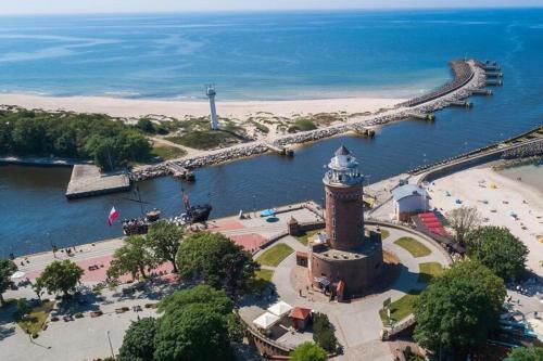 a lighthouse in the middle of a body of water at Apartment in Kolobrzeg with parking space in Kołobrzeg